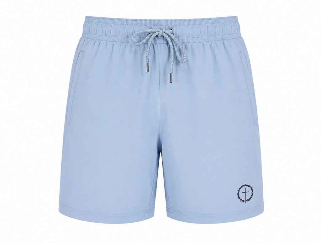 Light blue athletic shorts with an elastic drawstring waistband and a small circular cross logo on the lower left leg, shown against a plain white background.