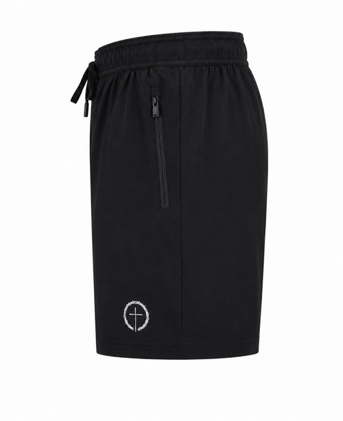 Black dry-fit shorts with side zipper pocket and logo graphic on left leg.
